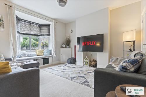 a living room with two couches and a tv at The Old Post Office 5 mins Drive to Alton Towers in Alton