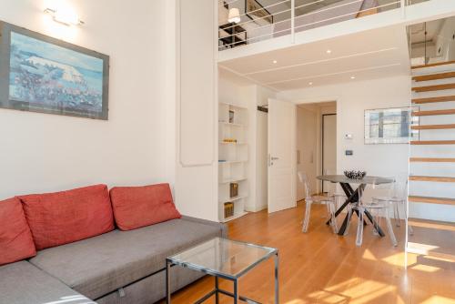 a living room with a couch and a table at The great window by Toh Solution in Turin
