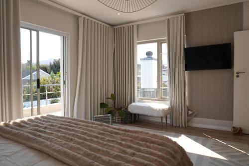 a bedroom with a large bed and a large window at Pine Villa 3 bed with pool Pine Villa in Tokai