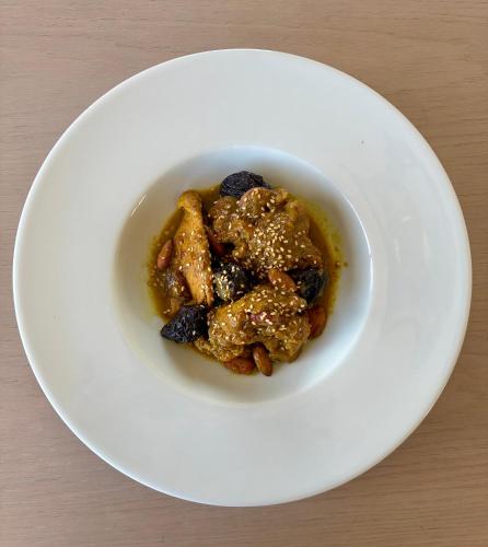 a white plate with a bowl of food on a table at RIBA D'AUDE SPA privatif proximité aéroport et de la Cité médiévale in Carcassonne