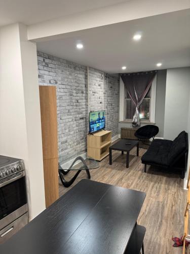 a living room with a table and a couch at Cozy apartment on Richmond st London Downtown in London