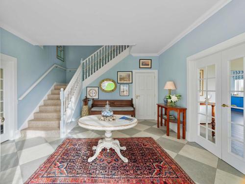 a living room with a staircase and a table at Fairmont St Andrews, Scotland in St. Andrews