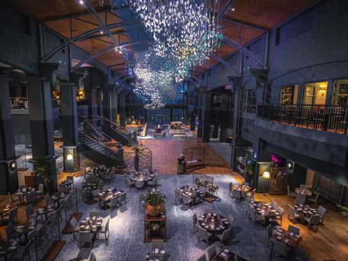 an overhead view of a restaurant with tables and a chandelier at Fairmont St Andrews, Scotland in St. Andrews