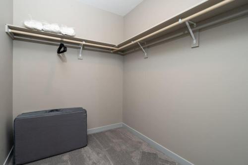 a room with white walls and a suitcase in it at Cozy Lux Haven Whitestown in Whitestown