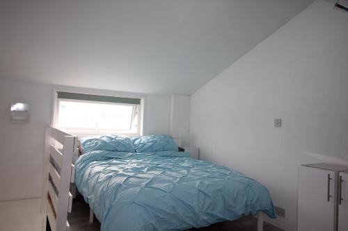 a small bedroom with a bed and a window at Fabulous Waterfront Apartment in Brighton Marina in Brighton & Hove