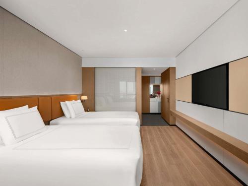 Ένα ή περισσότερα κρεβάτια σε δωμάτιο στο Swissotel Beijing Hong Kong Macau Center - 1 min to subway