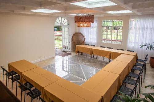 a room with rows of tables and chairs in it at MiraNamin Nest KAMANTIGI Room in Unique Historic Home - Garden Access, Shared Kitchen, Pet Friendly with a Fee in Manila