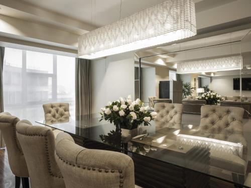 a living room with a glass table and chairs at Swissotel Lima in Lima
