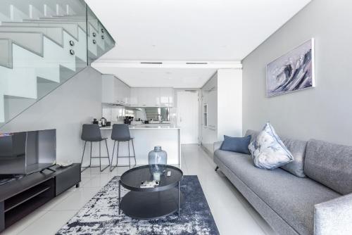 a living room with a couch and a table at The Park Central Residence - WITH GENERATOR in Johannesburg