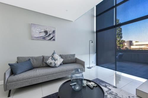 a living room with a couch and a table at The Park Central Residence - WITH GENERATOR in Johannesburg