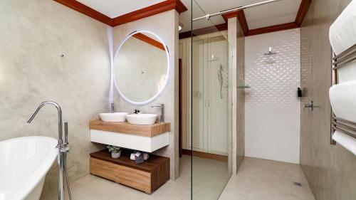 a bathroom with a sink and a mirror at Knysna Pearl View Guest House in Knysna