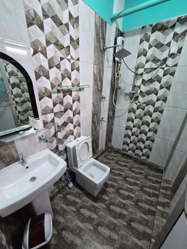 a bathroom with a shower and a toilet and a sink at Nethu beach villa in Trincomalee