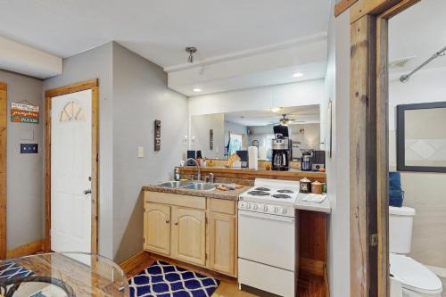 a kitchen with a white stove and a sink at Hickory Hideaway on the Lake in Lake Ozark