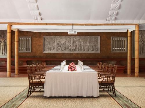 a long table in a room with chairs at Raffles Grand Hotel d'Angkor in Siem Reap