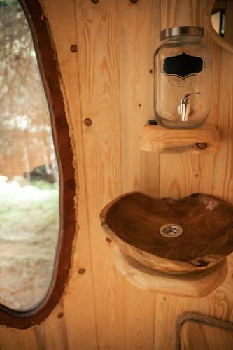 a bathroom with a wooden sink on a wooden wall at Veža v korunách stromov in Veličná
