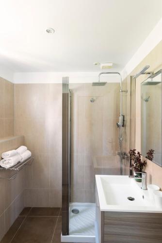 a bathroom with a shower and a sink and a tub at San Giovanni in Porto-Vecchio