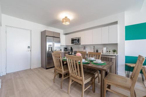 a kitchen and dining room with a table and chairs at Event-Ready 2BR 2BA Near Stadium & Beach includes Parking and Washer and Dryer in Hallandale Beach