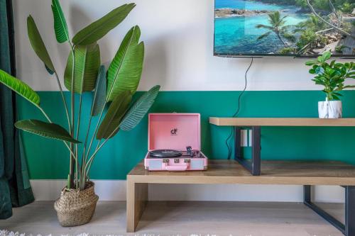 a living room with a table and a plant at Event-Ready 2BR 2BA Near Stadium & Beach includes Parking and Washer and Dryer in Hallandale Beach