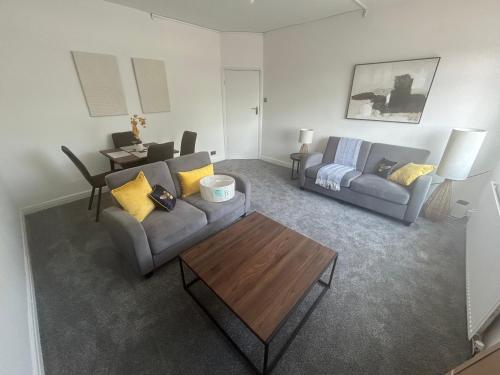 a living room with a couch and a table at The King Stay in Manchester