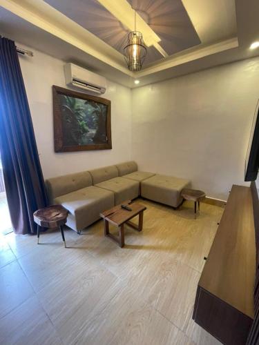 a living room with a couch and a table at Presken Residence in Ikeja