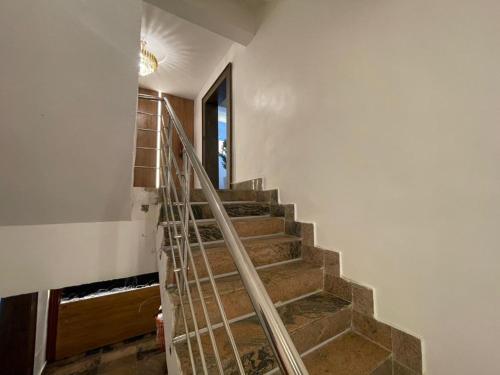 a staircase in a house with a metal railing at Presken Residence in Ikeja