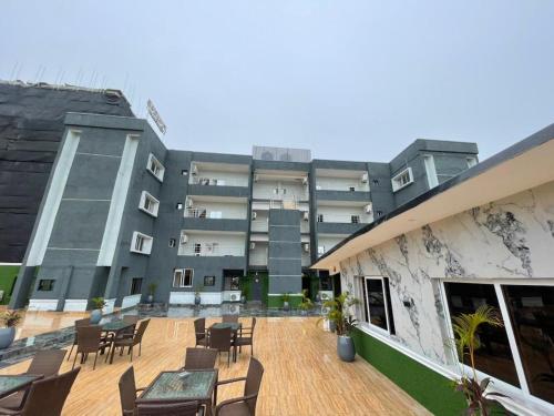 a building with chairs and tables in front of it at Presken Residence in Ikeja