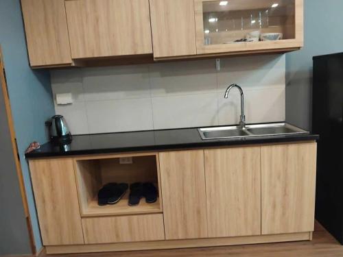 a kitchen with a sink and some shoes in it at Lemon Apartment Quy Nhơn in Quy Nhon