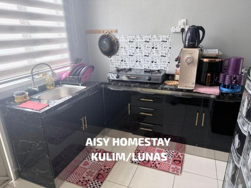 a kitchen with a sink and a counter top at AISY HOMESTAY KULIM/LUNAS in Kulim