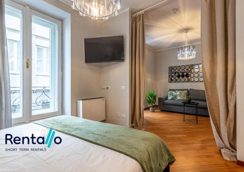 a bedroom with a bed and a living room at Duomo Delight Suite - 200 meters from the Duomo in Milan