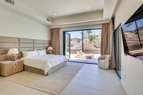 a bedroom with a bed and a sliding glass door at Luxurious Getaway on Lake Havasu Golf Course! in Lake Havasu City