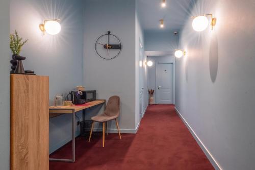 a hallway with a desk and a chair in a room at HB Freeze Inn in Tbilisi City