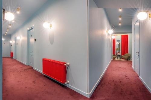a corridor with a red carpet in a room at HB Freeze Inn in Tbilisi City