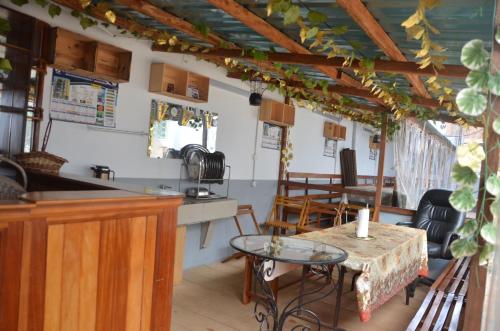 a kitchen with a table and some chairs at VICTOR & VICTORY GUEST HOUSE DAMAS-RAIL OBOBOGO Source in Yaoundé