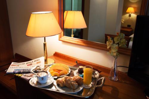 a tray of breakfast food on a table in a hotel room at Hotel Visconti in Melzo