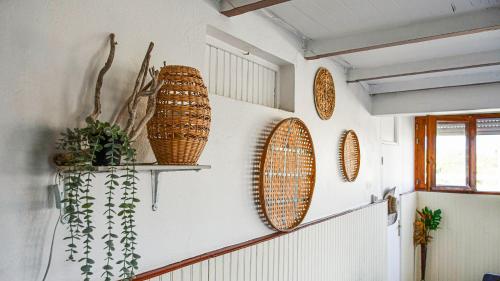 a room with three wicker baskets on the wall at Hotel Oasis in Grande Anse
