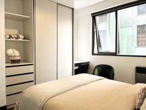 a bedroom with a bed and a window and a desk at Sky Suites - Amazing Location in La Paz