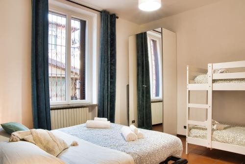 a bedroom with two beds and a bunk bed at Traveler's Retreat in Lecco in Lecco