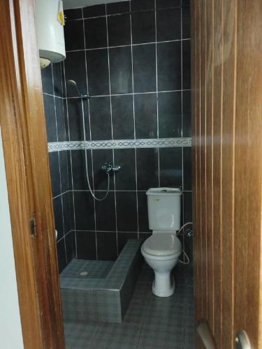 a bathroom with a toilet and a bath tub at Sako's Home 