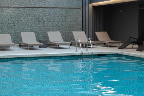 a group of chairs and a swimming pool at Altis Grand Hotel in Lisbon