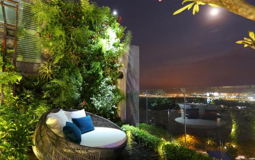 a balcony with a chair and a view of the city at Silverland Jolie Hotel in Ho Chi Minh City