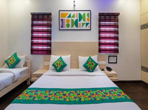 a bedroom with a bed and two pillows at Hotel Olive Aero Suites Near Delhi IGI Airport in New Delhi