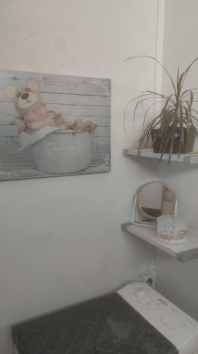 a bathroom with a picture of a baby in a bath tub at loue chambre chez l'habitant in Saint-Victoret