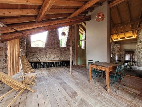 a dining room with a wooden table and chairs at Il Ronchetto in Cunardo