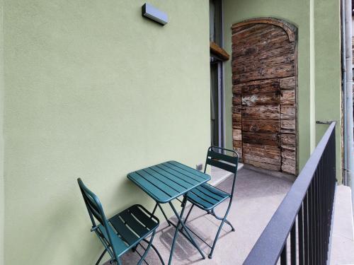 a blue table and chairs on a balcony at Il Ronchetto in Cunardo