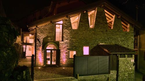 a brick house with pink lights on it at night at Il Ronchetto in Cunardo