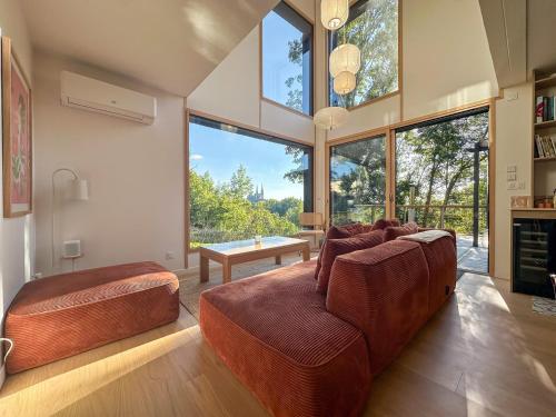 a living room with a couch and large windows at Le Spot - Bain Nordique – Vue Cathédrale in Chartres