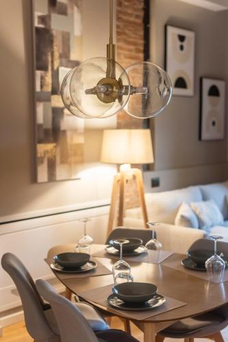a dining room table with chairs and a light fixture at Borgo Rotondo in San Giovanni in Persiceto