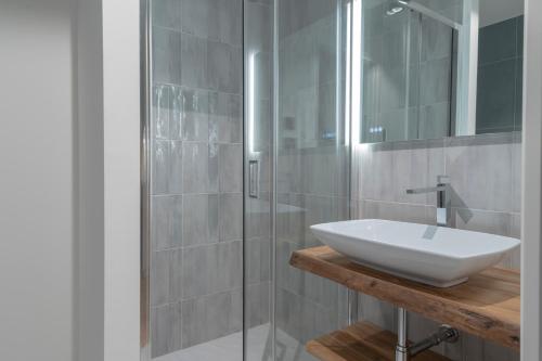 a bathroom with a sink and a glass shower at Borgo Rotondo in San Giovanni in Persiceto