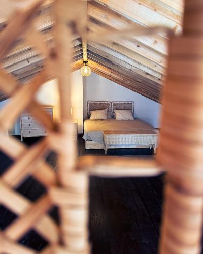 a bed in a room with a wooden ceiling at Brisa do Nordeste in Nordestinho