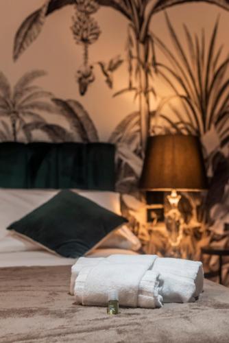 a pile of towels sitting on top of a bed at Borgo Rotondo in San Giovanni in Persiceto